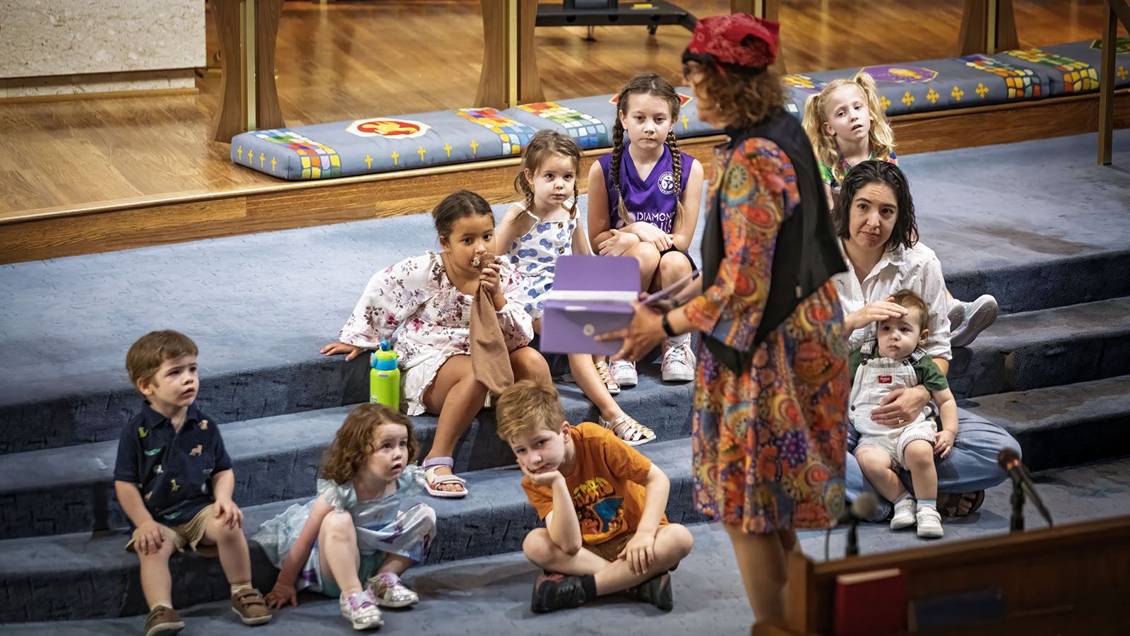 Children gather on the chancel steps for the children's message